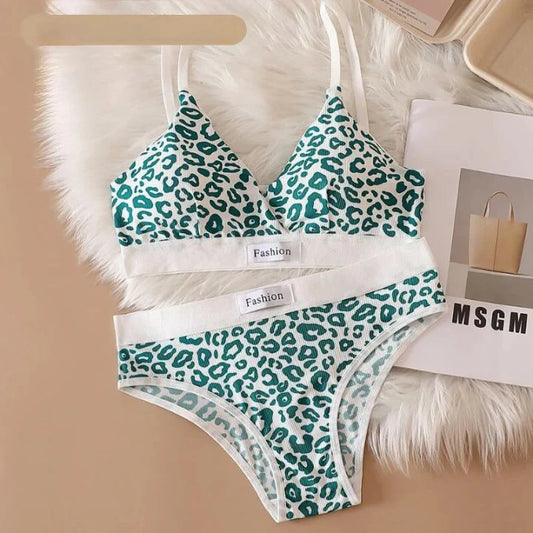 Green leopard print bra and panties set on a white fur surface with 'Fashion' label.