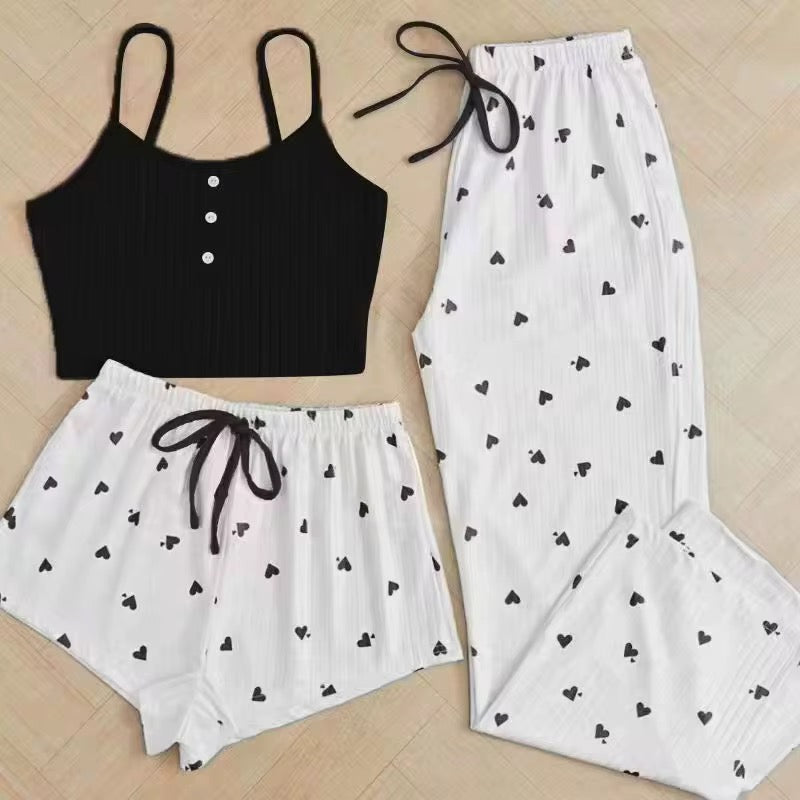 Black crop top and white shorts with heart patterns on a wooden floor.