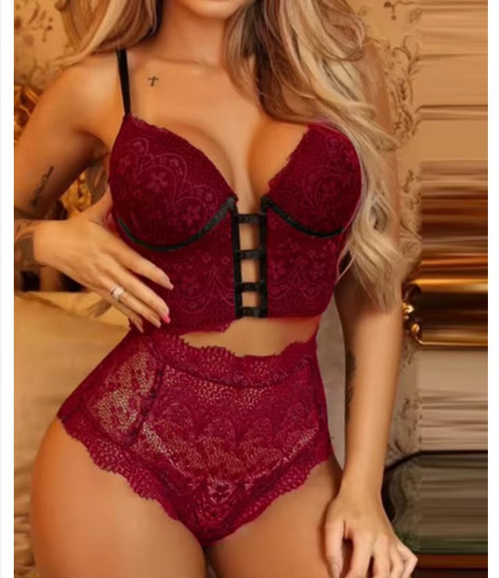 Woman wearing a red lace lingerie set with intricate designs.