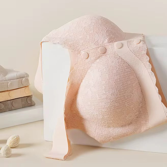 Light pink lace bra on a white surface with a neutral background