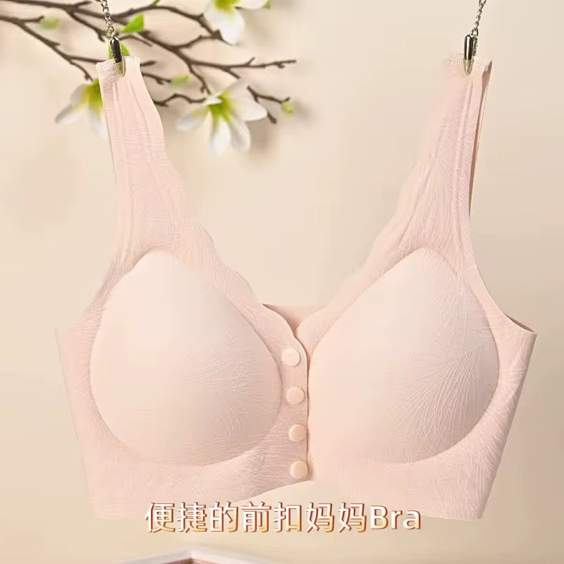 Pink bra with buttons hanging against a light background
