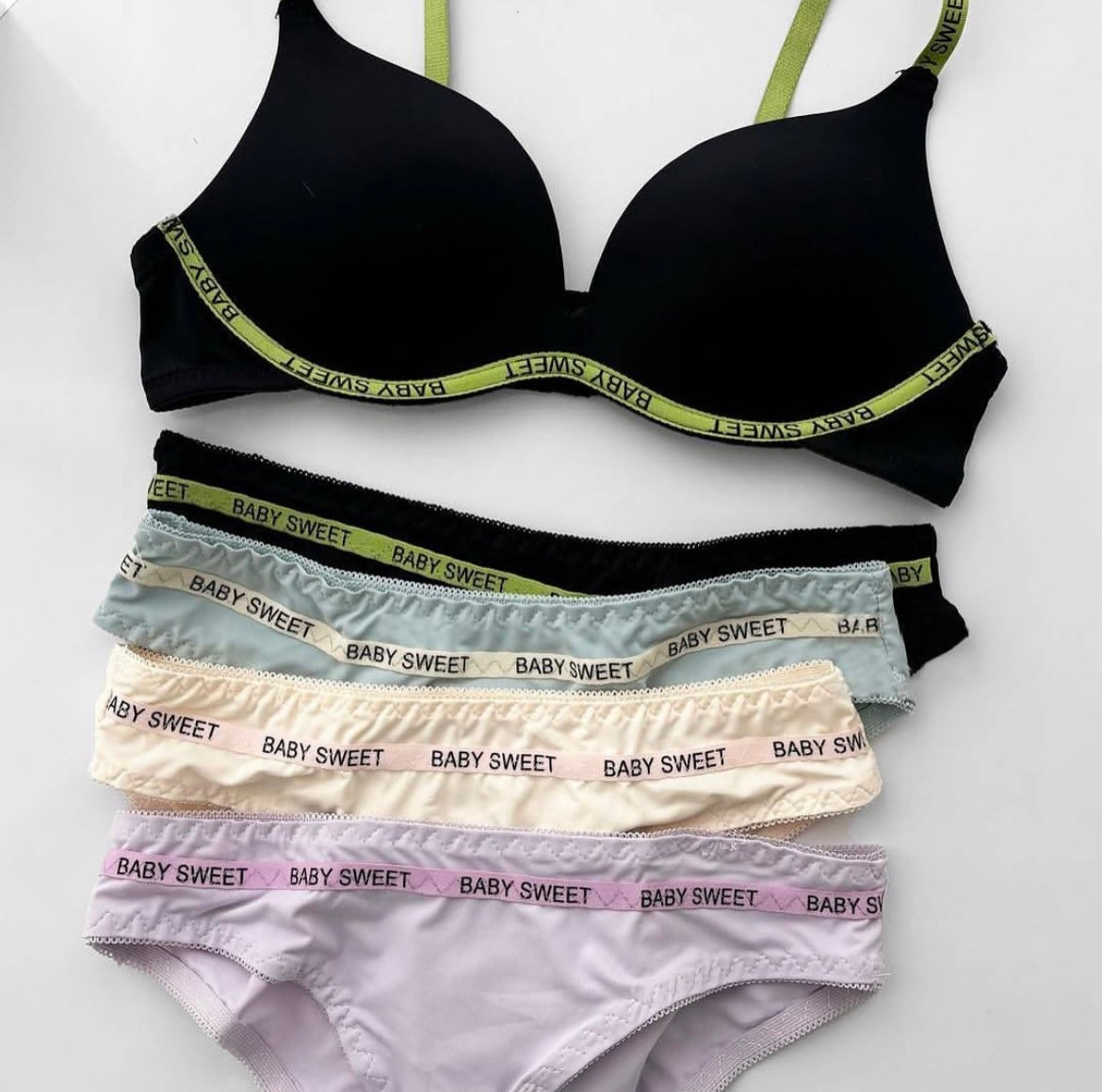 Black bra and panties set with 'Baby Sweet' branding on a white background