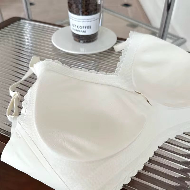 White bra on a metal surface with a container of coffee beans in the background.