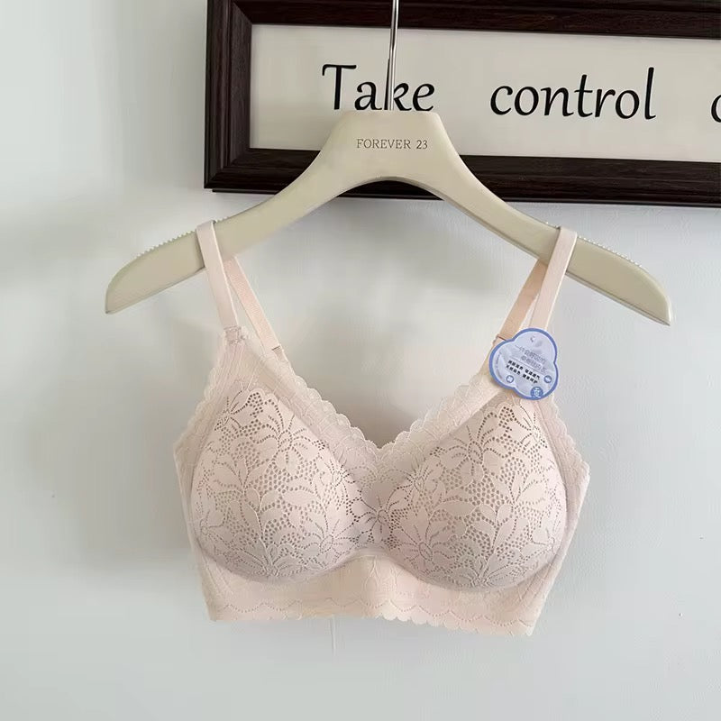 Pink lace bra on a hanger with a visible brand label against a light background.