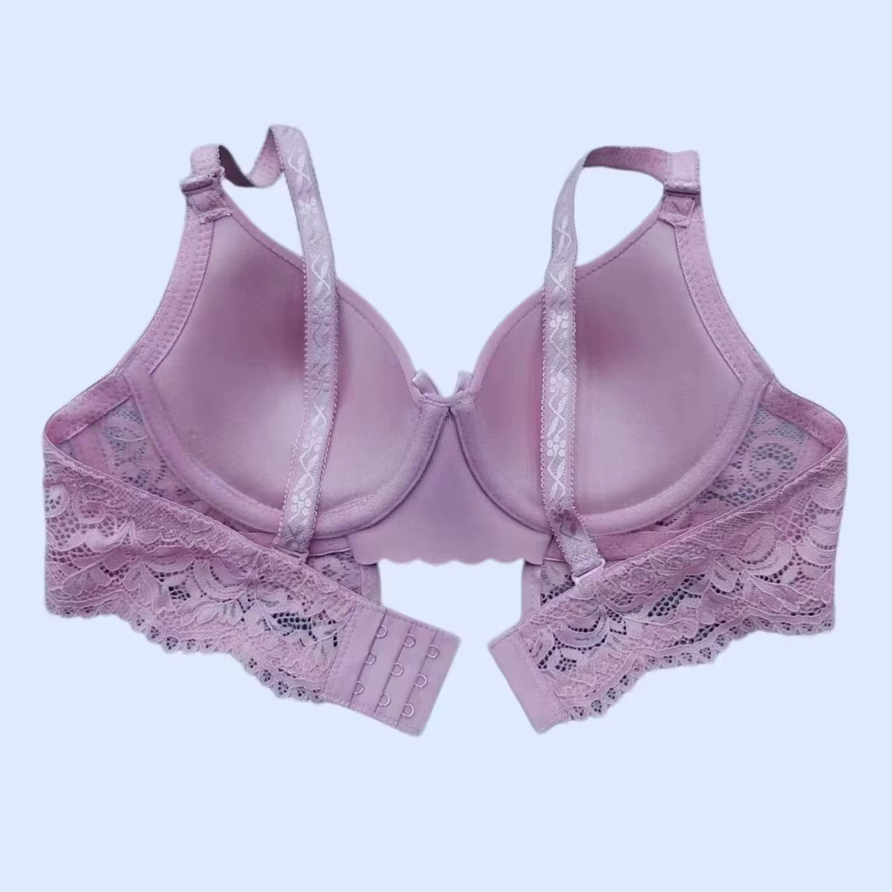 Pink bra with lace details on a light purple background