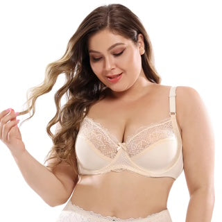 Woman wearing a beige bralette against a white background