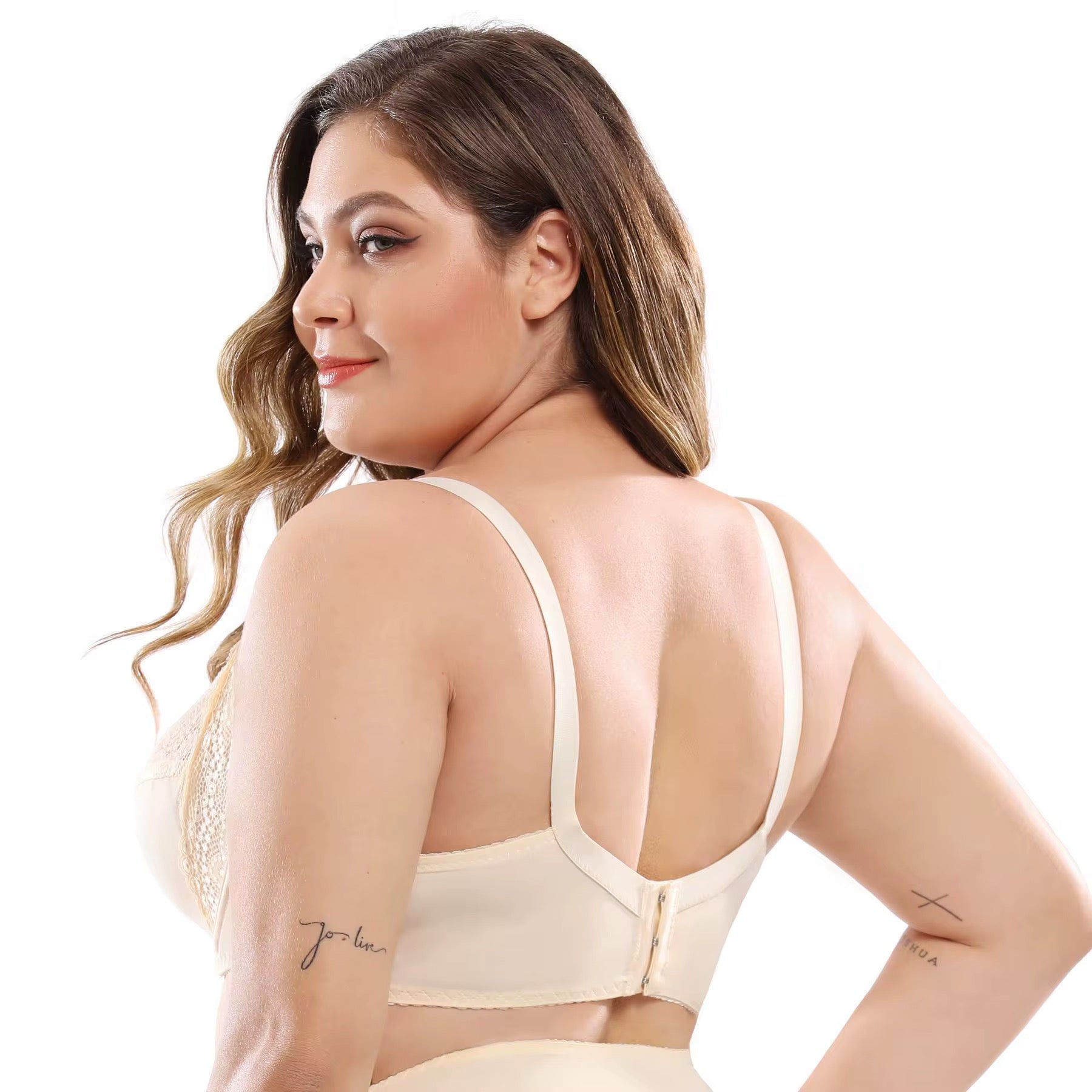 Woman wearing a beige bralette on a white background