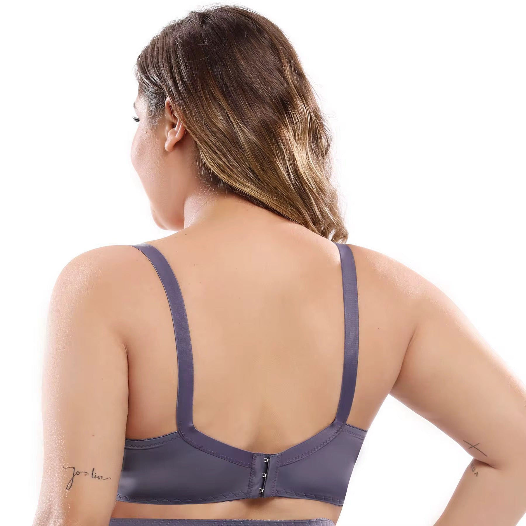 Woman wearing a gray sports bra on a white background