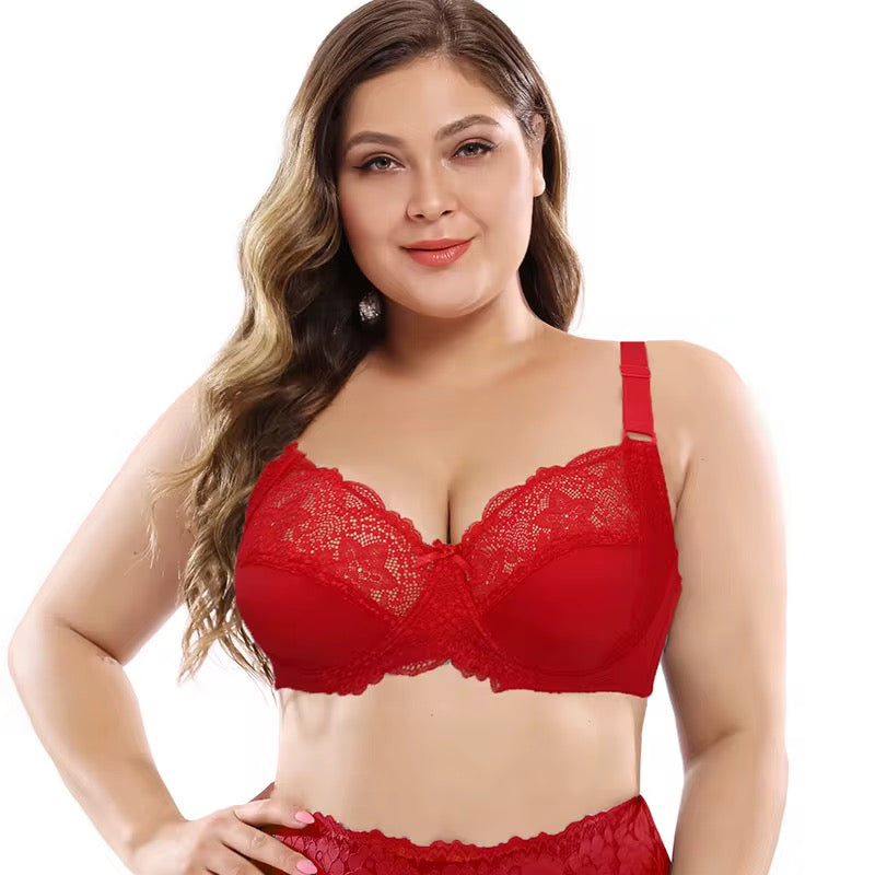 Woman wearing a red lace bra and panties set on a white background