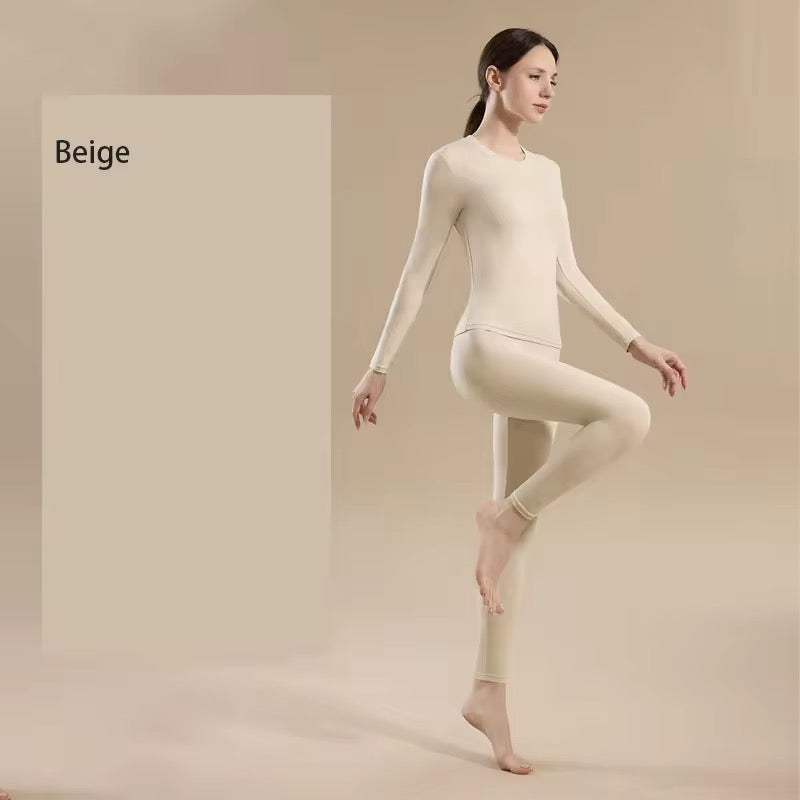 Woman wearing beige thermal underwear on a plain background