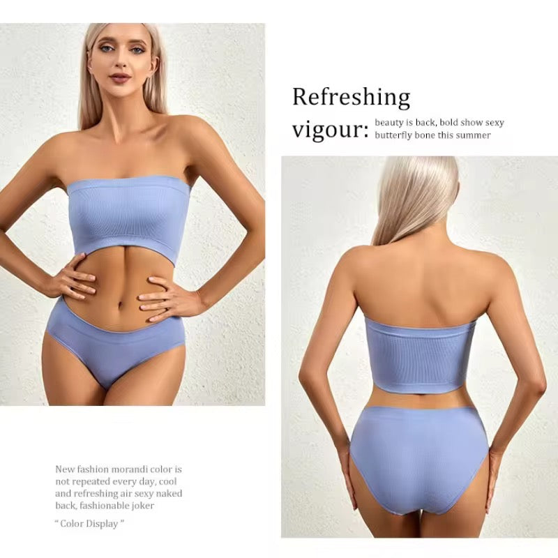 Woman wearing a light blue strapless top and high-waisted bottoms on a plain background.