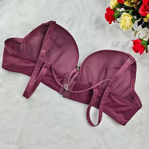 Purple bralette on a textured surface with flowers in the background