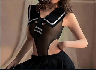 Person wearing a black dress with a white collar and trim against a neutral background