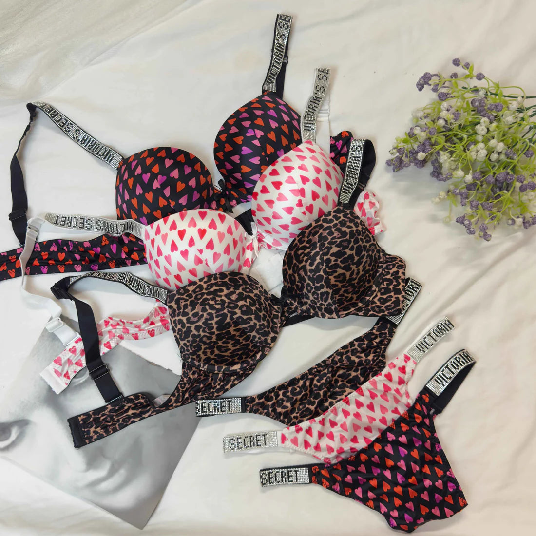 Collection of patterned lingerie with brand labels on a light background