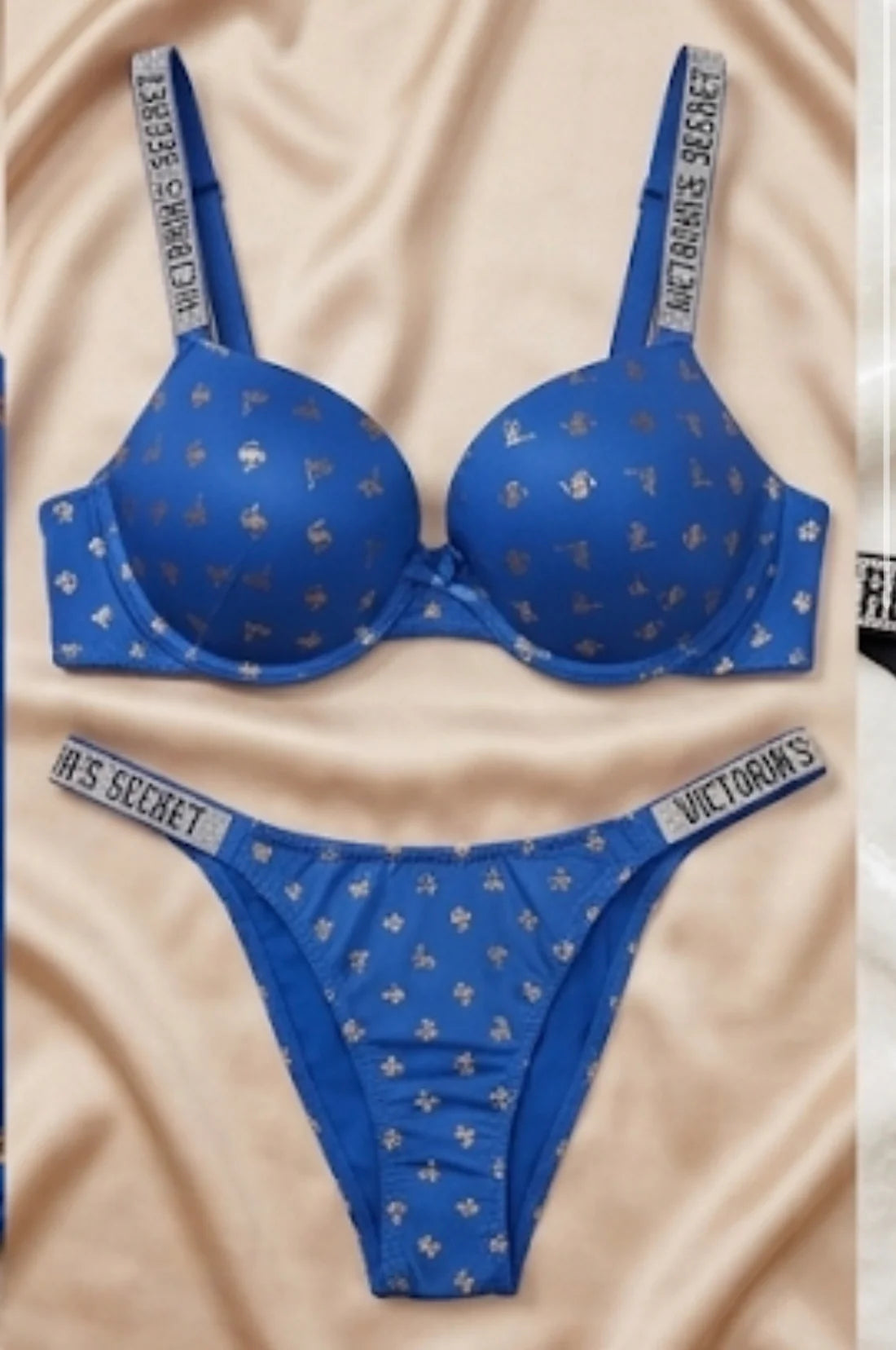 Blue Victoria's Secret bra and panties set on a beige fabric background