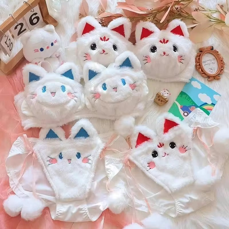 Set of cute cat-themed plush toys on a soft pink background
