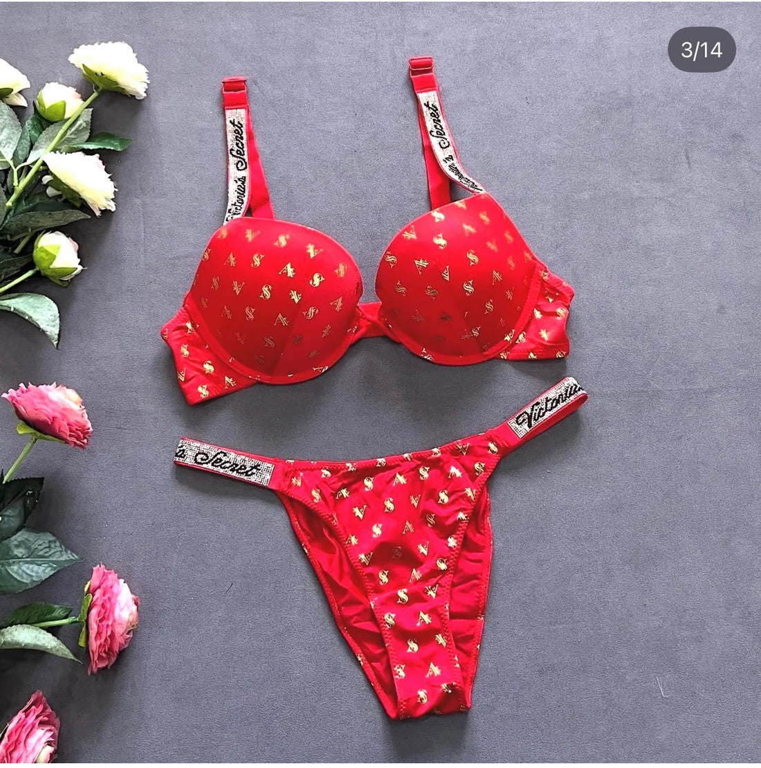 Red lingerie set with floral design on a gray background
