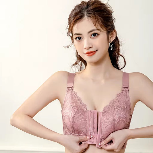 Woman wearing a pink lace bra against a plain background