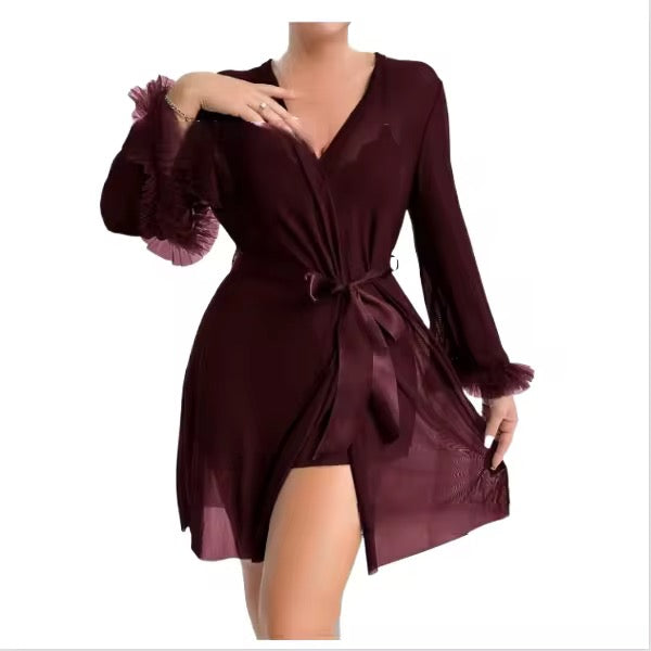 Burgundy dress with long sleeves and a tie waist on a white background