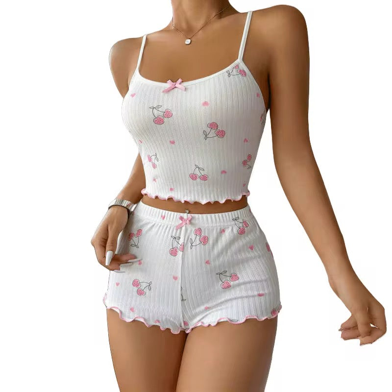 White pajama set with pink cherry pattern on a white background