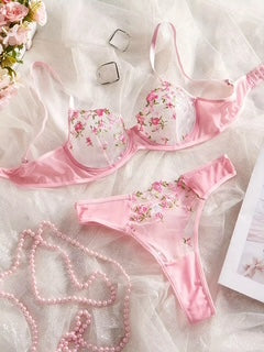 Pink floral lingerie set on a white background