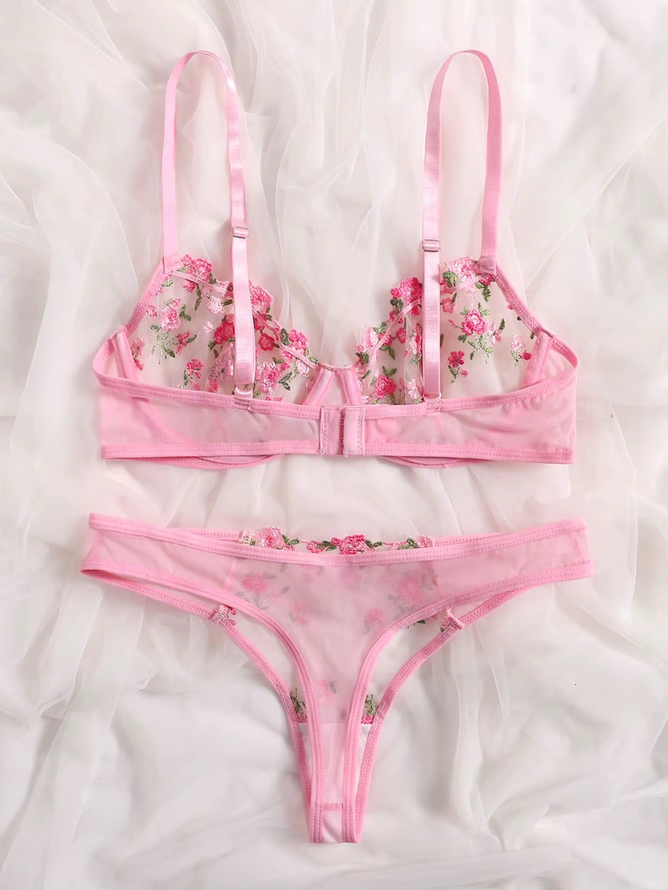 Pink floral lingerie set on a white background