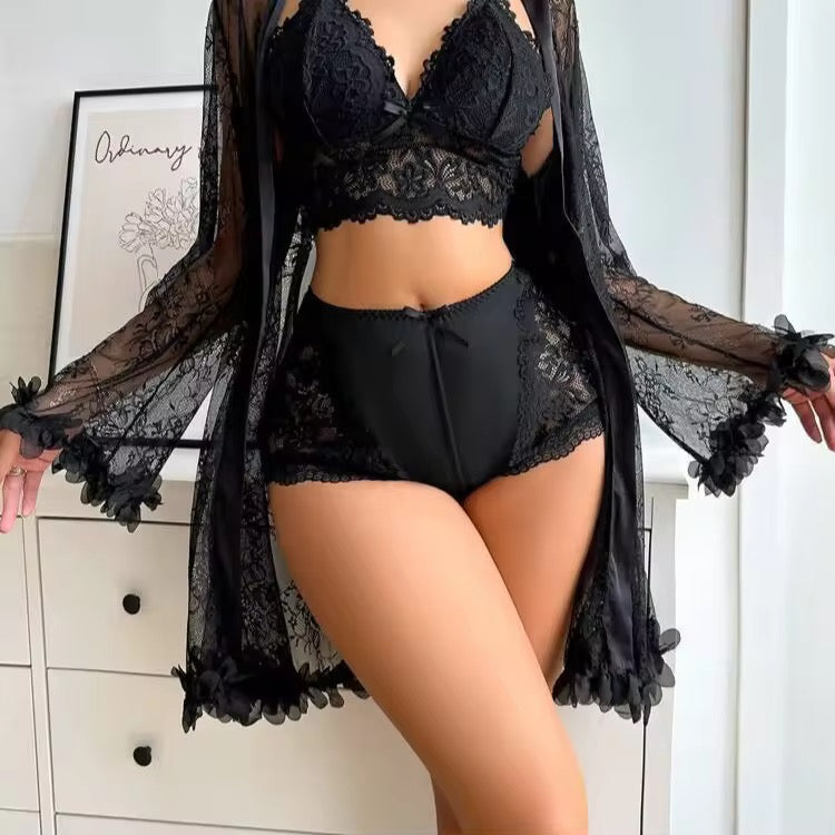Person wearing black lace lingerie set with a sheer black robe.