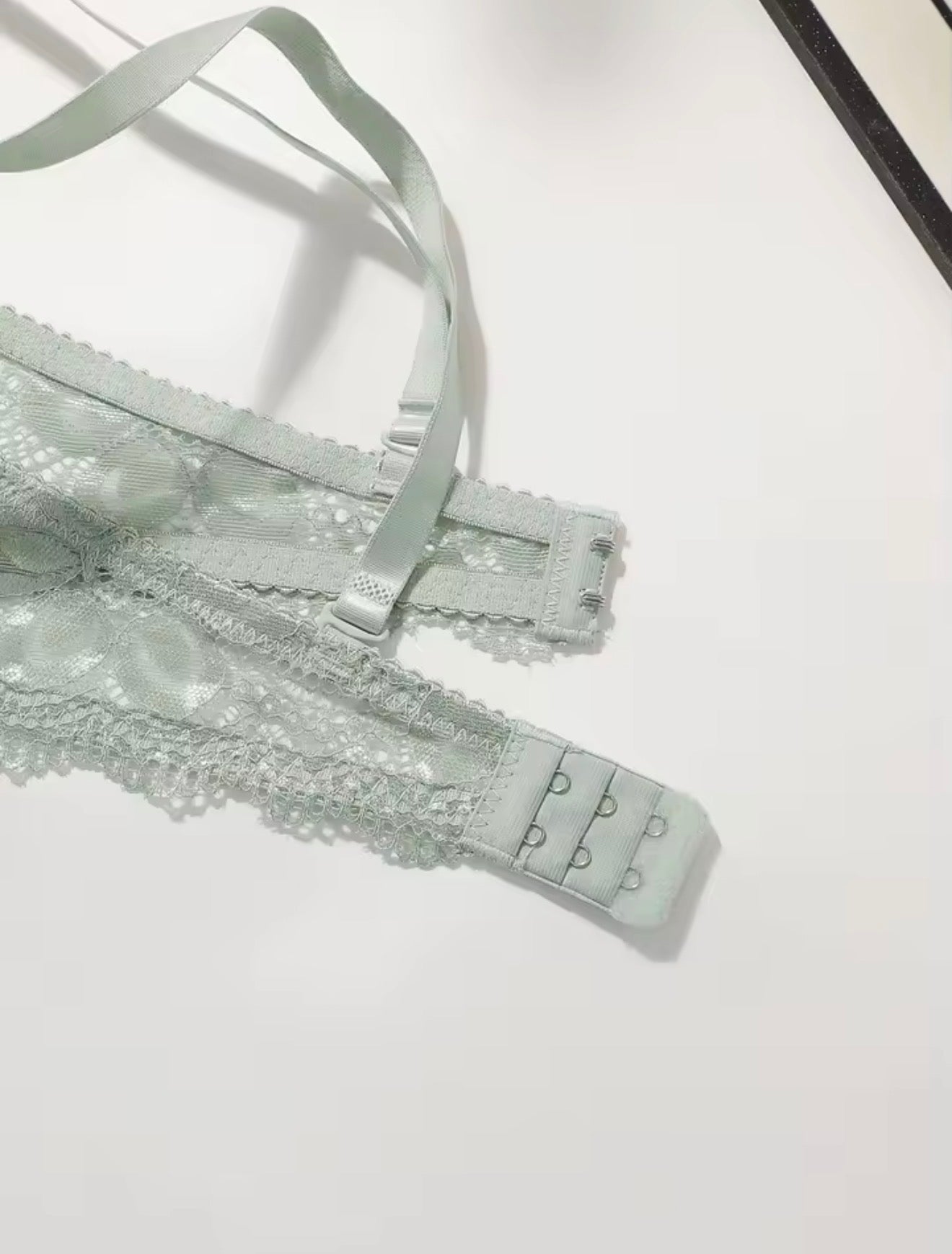 Silver lace lingerie set on a white background