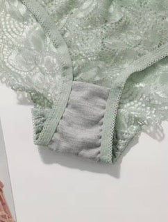 Green lace fabric on a white background
