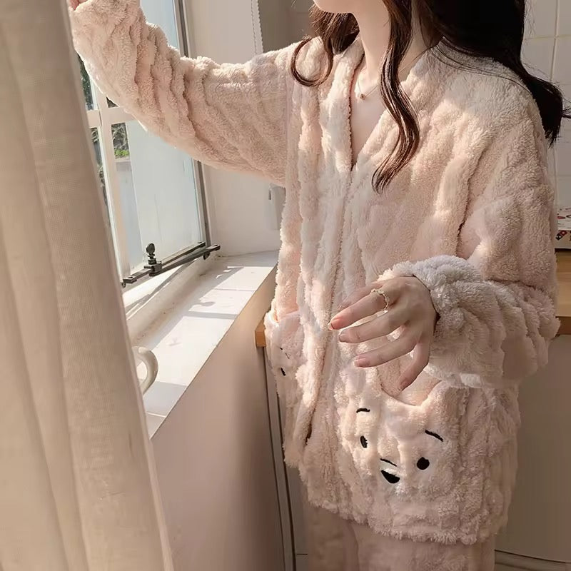Person wearing a fluffy pink pajama set with animal face designs in a bright room.