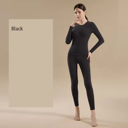 Woman wearing a black long-sleeve top and leggings against a beige background