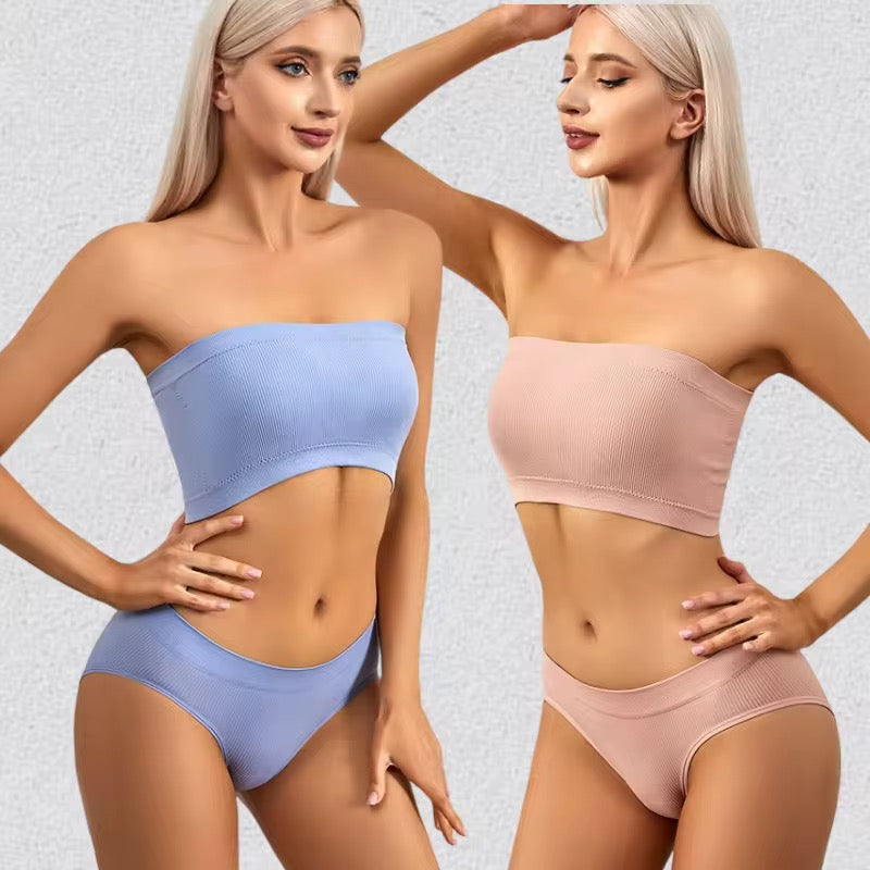 Two women wearing light blue and pink strapless tops and underwear on a neutral background