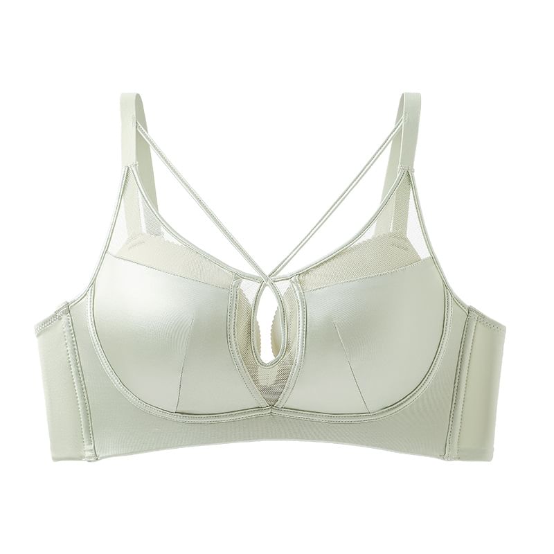 Light green bra with thin straps on a white background