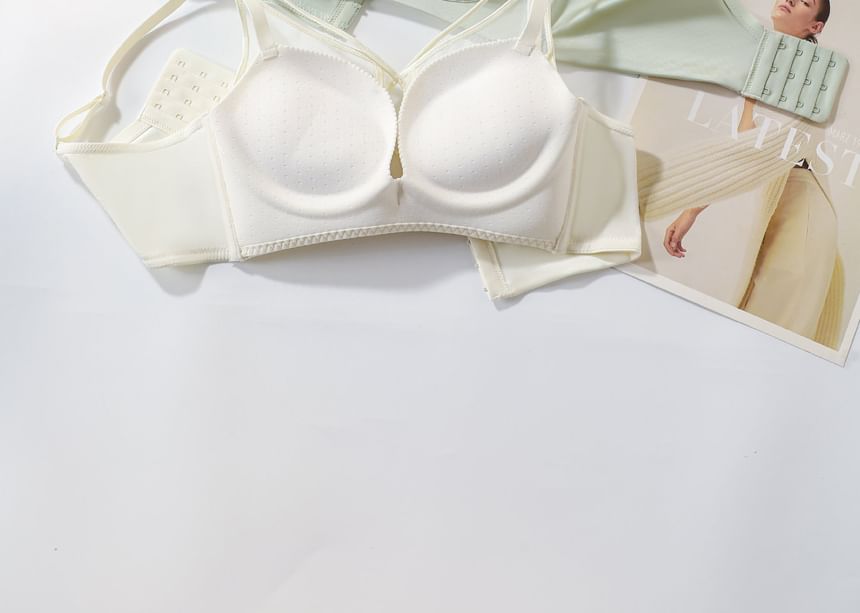 White bra on a white surface with a magazine in the background