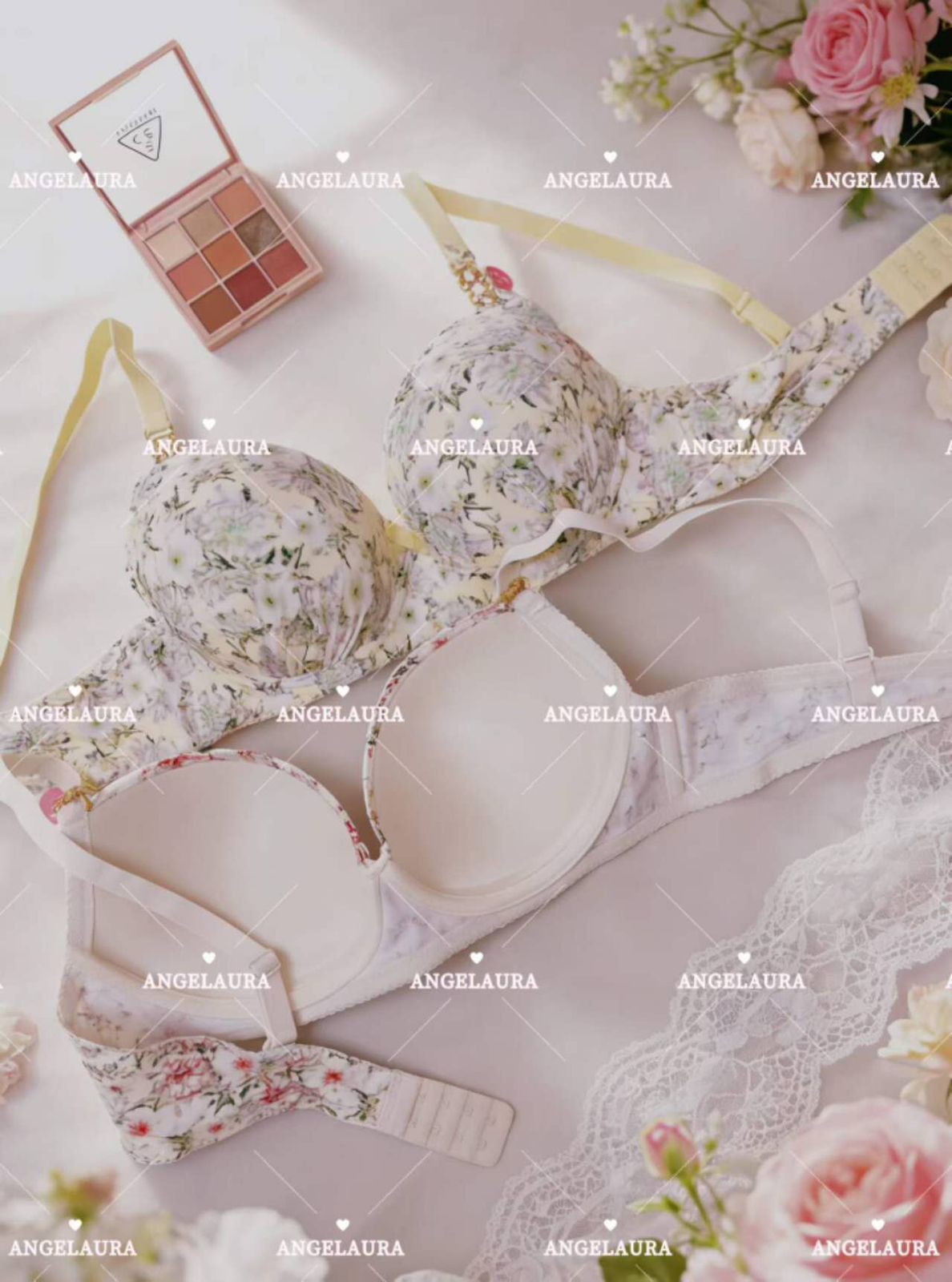 Floral lingerie set with makeup and flowers on a light background, featuring the brand 'ANGELAURA'.