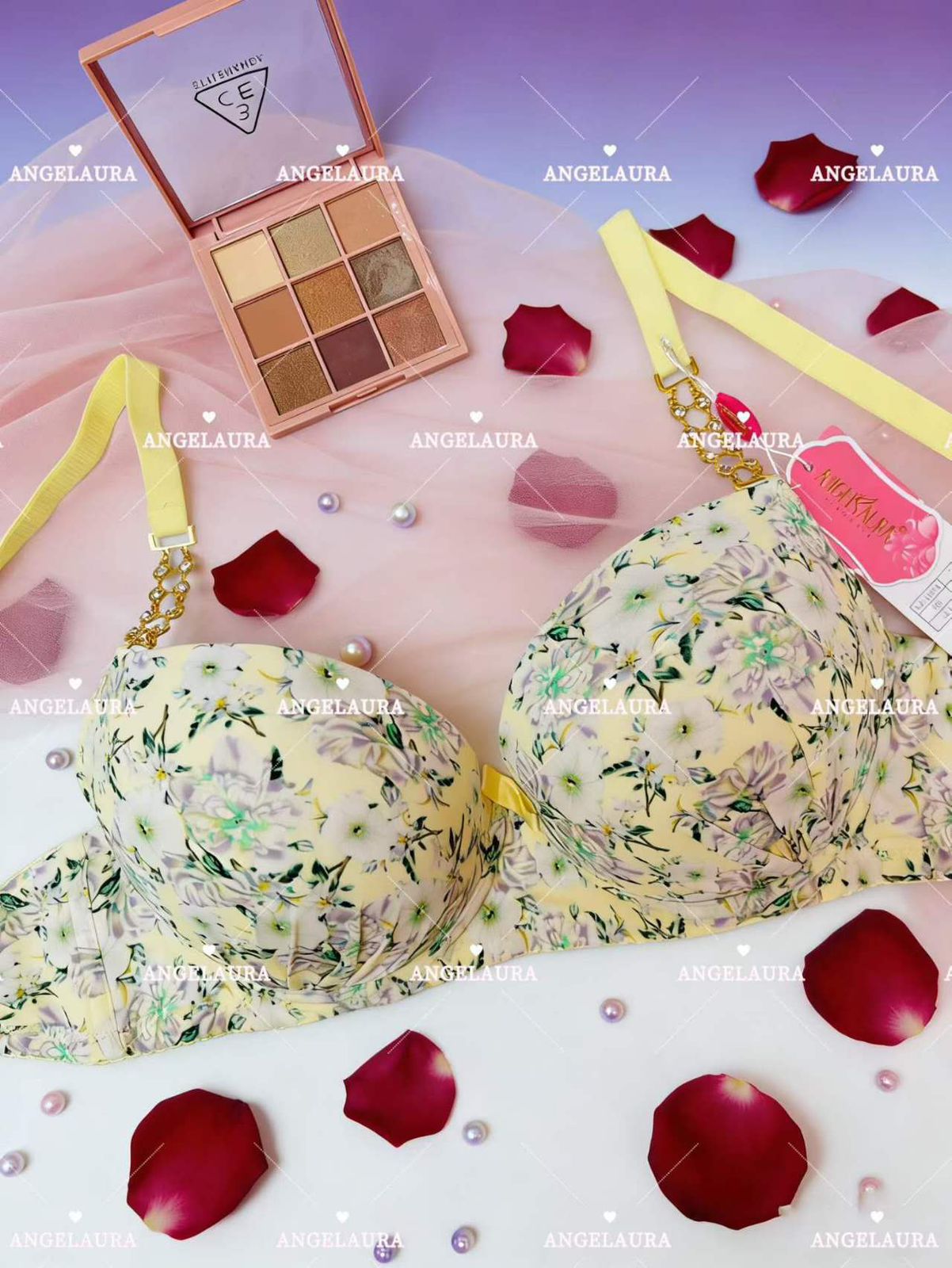 Floral bra with makeup palette and rose petals on a pink background