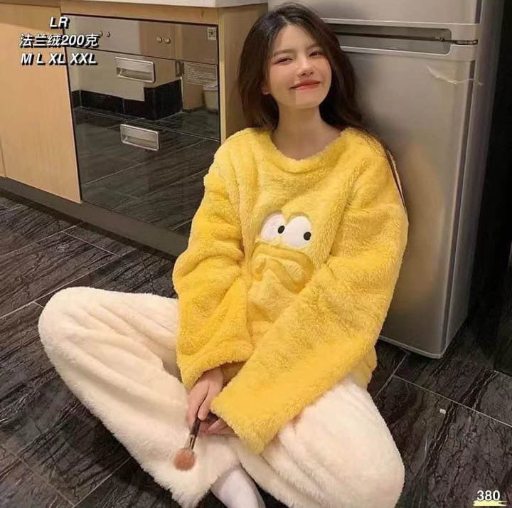 Person wearing a yellow fleece outfit sitting on the floor.